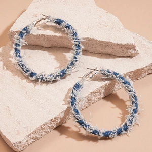 Retro geometric hoop earrings wrapped in blue denim fabric with fringe detail on stone