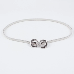 Detail of silver elastic spring waist belt with textured figure-eight metal buckle