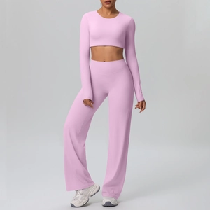 Detail of pink long sleeve crop top and high waist flared sports trousers yoga set