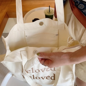 Minimalist beige canvas tote bag with beloved embroidery and metal magnetic closure