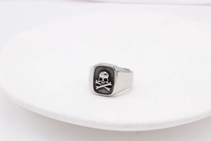 Macro view of retro square signet ring featuring 3D skull and crossbones design