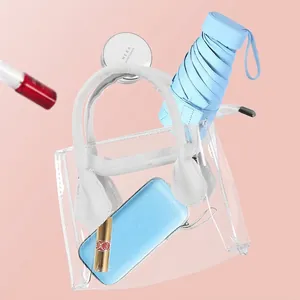 Compact six-fold flat umbrella with UV protection inside a transparent PVC tote bag