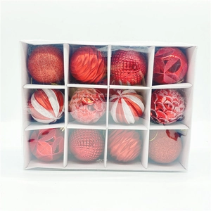 Detail of 12-pack red Christmas ornaments with glitter, matte and striped finishes in a box