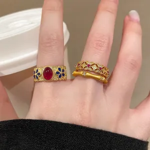 Detail of vintage s925 silver bamboo ring with gold enamel and red gemstone inlay