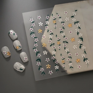 Detailed 5D floral nail stickers with gold embossed flowers and white petals on a sheet