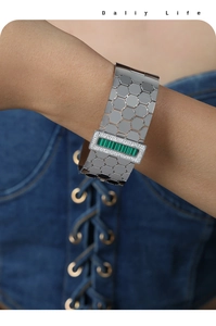 Detail of silver honeycomb cuff bracelet featuring a green malachite stone and small diamonds