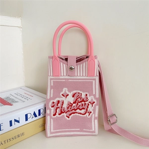 Close-up of pink knit phone bag with Happy embroidery and adjustable strap detail