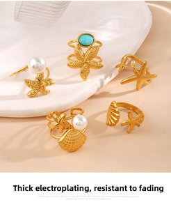 Detail of five gold ocean rings featuring starfish, shells, pearls, and turquoise stones