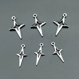 Flat lay of bright silver star charms for jewelry making in two assorted sizes