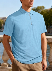 Detail of light blue waffle knit polo shirt featuring a modern half-zip collar design