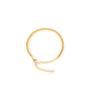 Close-up of golden stainless steel chain bracelet with lobster clasp and extender