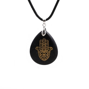 Close-up of teardrop blue sandstone necklace with golden Hamsa Hand symbol detail