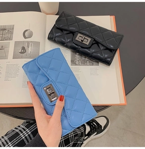 Detail of quilted texture and metal twist lock on black and blue long fashion wallets