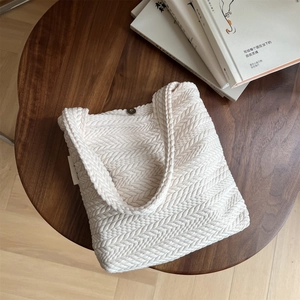 Close-up of rice grain woven canvas bag texture with metallic magnetic closure