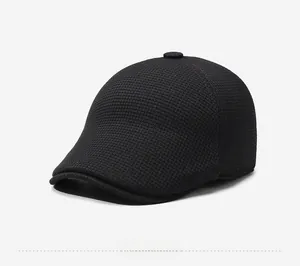 Close-up of side view showing textured black winter ivy cap with ear flaps and logo