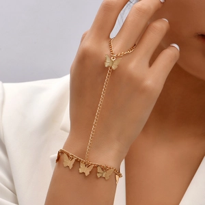 Detail of gold butterfly bracelet ring hand chain set worn on wrist and finger