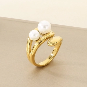 Detailed view of adjustable gold-finish ring featuring two white pearls on a textured stand