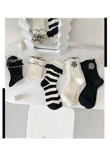 Detail of Lolita style knit socks with ruffle trim and 3D camellia floral appliques