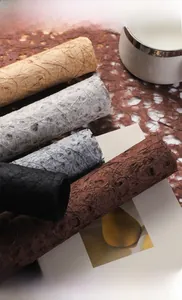 Detailed texture of hollow raffia fiber paper rolls in five natural gradient colors