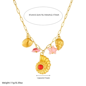 Gold stainless steel beach necklace with shell, starfish and pink hat charms on white background