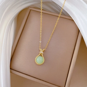 Titanium steel necklace with green gemstone pendant and diamonds in a jewelry box