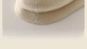 Detail of fine flat-stitched toe seams and soft knit texture on cream cotton socks