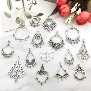 Detailed flat lay of ornate vintage silver alloy pendants for DIY jewelry making