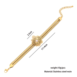 Close-up of golden floral bracelet featuring double snake chain with detailed size markings
