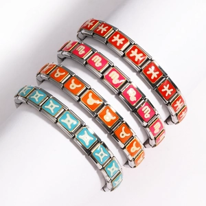 Detail view of zodiac charm bracelets in blue, orange, pink and red enamel on stainless steel