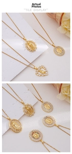 Detailed view of 18k gold plated Virgin Mary pendants with colorful cubic zirconia stones