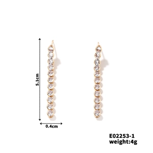 Detail view of gold tassel earrings with white zircon, size 5.1cm by 0.4cm, weight 4g