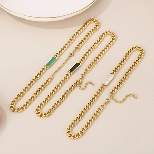 Three gold Cuban chain necklaces with rectangular pendants in green, black, and white colors