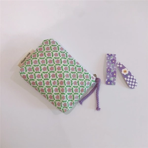 Detail of floral cotton coin purse with purple flower pattern and simple wish label