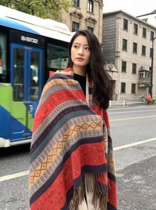 Ethnic style pashmina shawl with geometric floral patterns and tassels in urban street setting