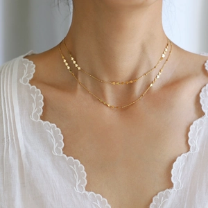 Close-up of double layer gold plated heart choker necklace on model's neckline