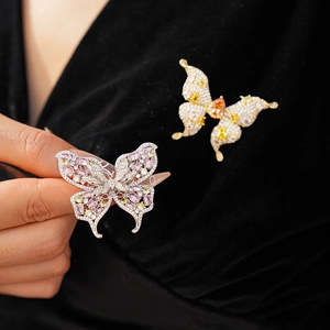 Detailed macro of crystal butterfly brooch with colorful cubic zirconia on black fabric