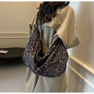 Fashionable leopard print oversized shoulder bag styled on a khaki trench coat