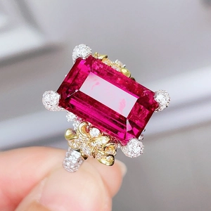 Elegant camellia open ring featuring a large pink rectangular gemstone with accent stones