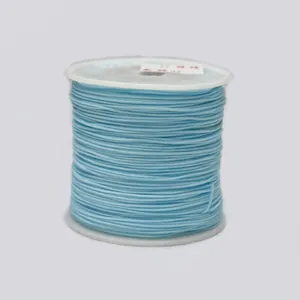 Detailed view of light blue 0.8mm braided cord wound neatly on a white plastic spool