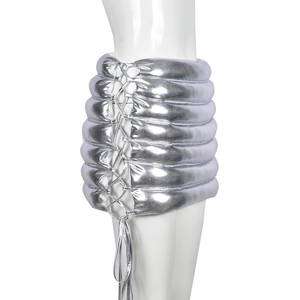 Close-up of silver metallic mini skirt featuring padded quilted texture and side lacing detail