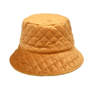 Close-up of quilted diamond pattern on ginger brown velvet bucket hat for winter