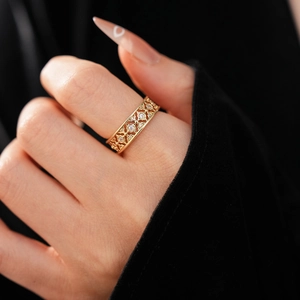 Detail of 18K gold plated vintage open ring with hollow carvings and zircon stones