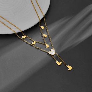 Double-layered gold titanium steel heart necklace with mother of pearl pendant on silk fabric
