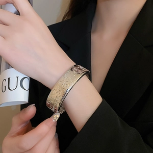 Macro view of vintage silver wide open cuff with intricate baroque embossed patterns