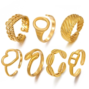 Set of 7 gold stainless steel open rings with heart, snake, and geometric patterns
