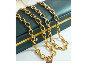 Detailed view of heavy gold cuban link necklace with interlocking oval rings and double loops