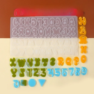 Macro shot of 26 letters and numbers silicone mold with colorful DIY resin pieces