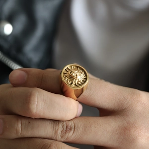 Macro shot of gold lion head signet ring in vintage stainless steel style on hand