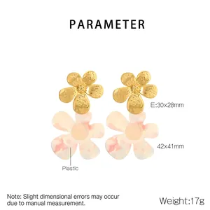 Macro detail of stainless steel flower earrings with pink marble texture finish