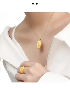 Macro view of textured golden lava pendant and ring set with small white crystals